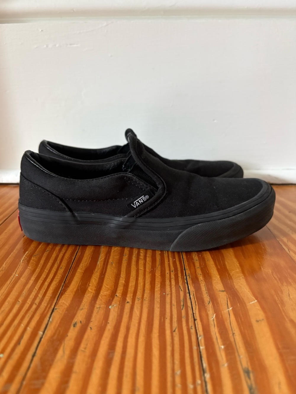 Kids all black slip on Vans